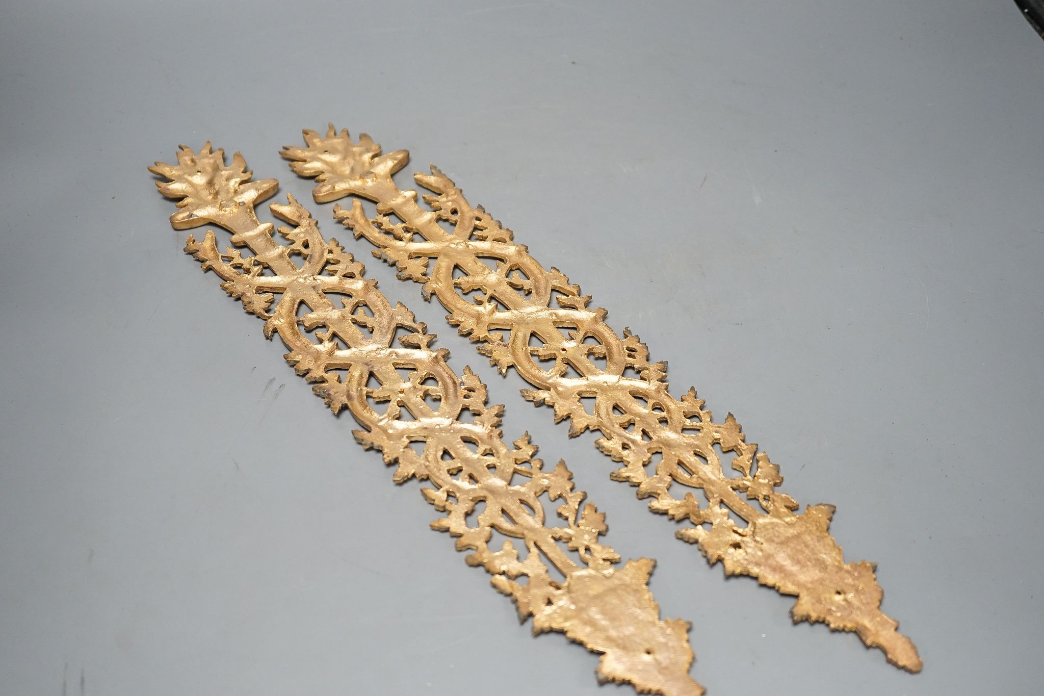 A pair of ormolu furniture mounts, circa 1900, 48cm long